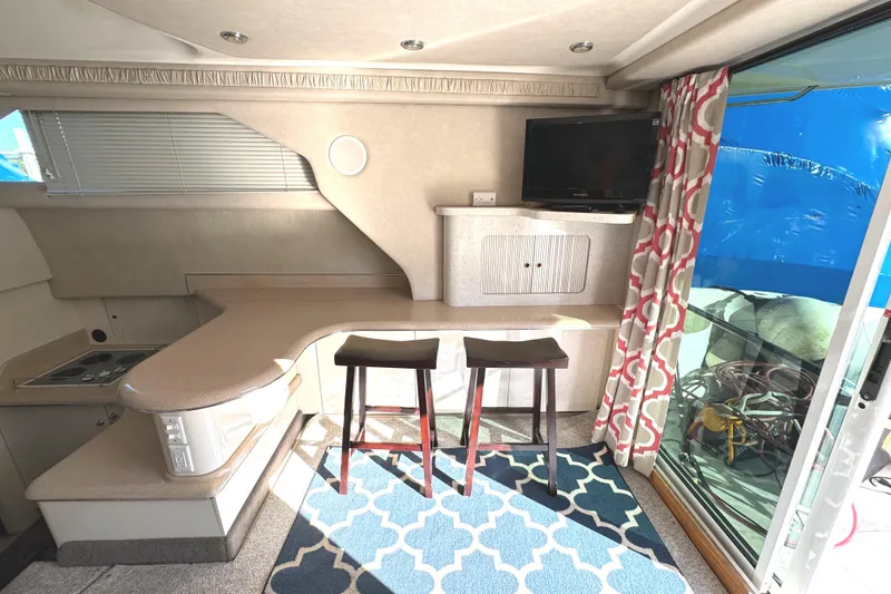Slide: The Image of Interior of 1996 Sea Ray 400 Sedan Bridge with modern kitchen and seating area. - 33