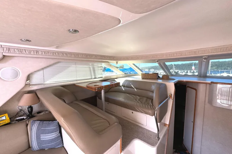 Slide: The Image of Interior of 1996 Sea Ray 400 Sedan Bridge with beige seating and large windows. - 35