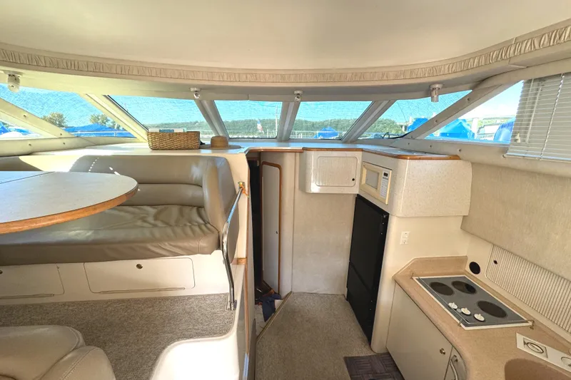 Slide: The Image of Interior of 1996 Sea Ray 400 Sedan Bridge with kitchen and seating area. - 37