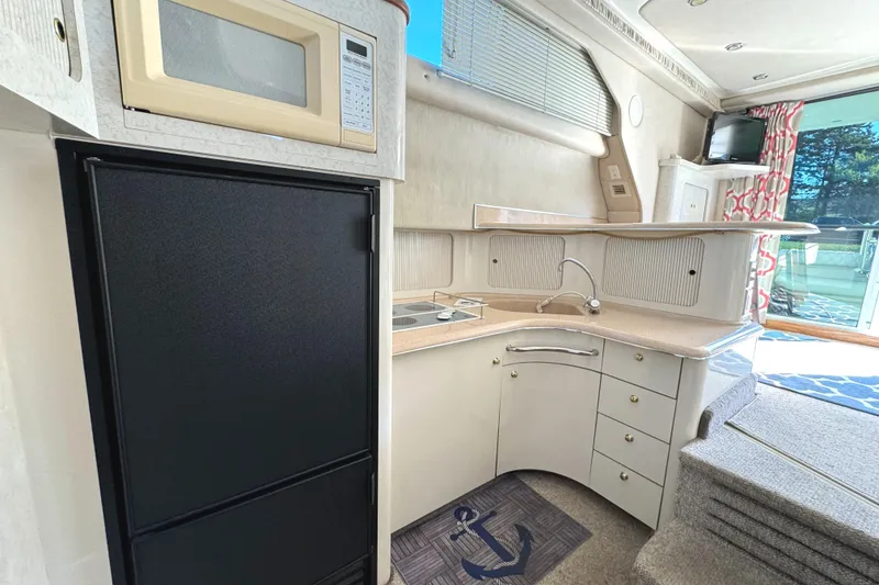 Slide: The Image of Interior of 1996 Sea Ray 400 Sedan Bridge yacht kitchen with microwave and fridge. - 39