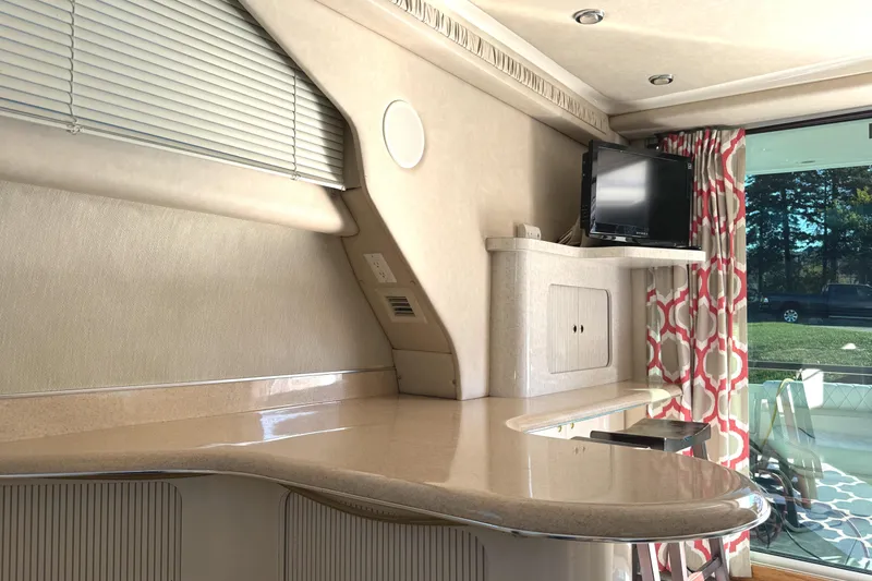 Slide: The Image of Interior of 1996 Sea Ray 400 Sedan Bridge with TV, counter, and window view. - 41
