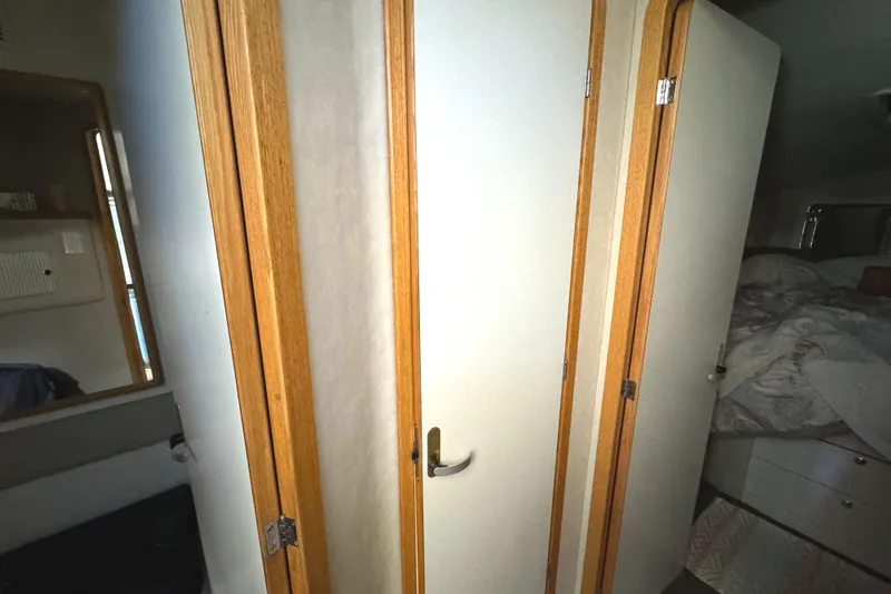 Slide: The Image of Interior of 1996 Sea Ray 400 Sedan Bridge with wooden doors and cozy cabin space. - 46