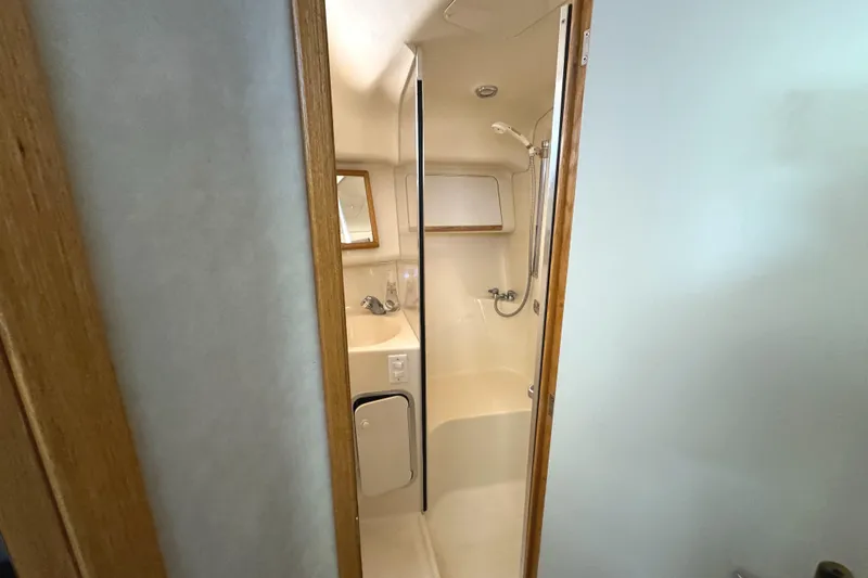 Slide: The Image of Bathroom interior of 1996 Sea Ray 400 Sedan Bridge yacht, featuring shower and sink. - 47