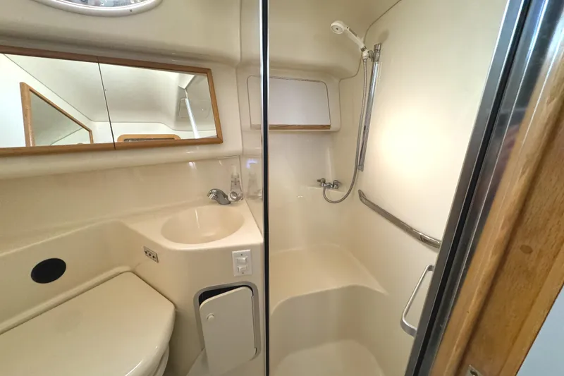 Slide: The Image of Bathroom interior of 1996 Sea Ray 400 Sedan Bridge yacht, featuring shower and sink. - 49