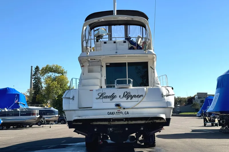 Slide: The Image of 1996 Sea Ray 400 Sedan Bridge yacht on land, rear view, sunny day. - 7