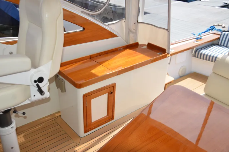 Slide: The Image of 2003 Little Harbor WhisperJet 38 interior with polished wood and modern navigation equipment. - 11