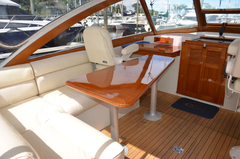 Slide: The Image of Interior of 2003 Little Harbor WhisperJet 38 with wooden table and cream seating. - 12