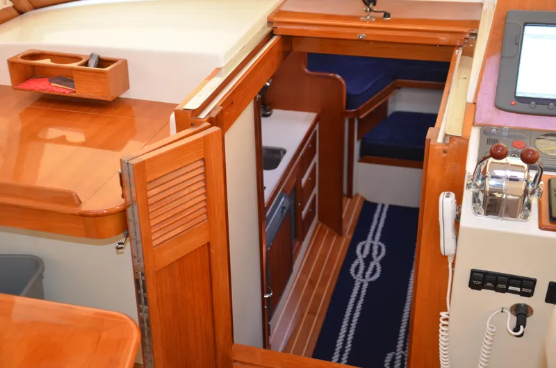 Slide: The Image of 2003 Little Harbor WhisperJet 38 interior with wooden trim and cushioned seating. - 15