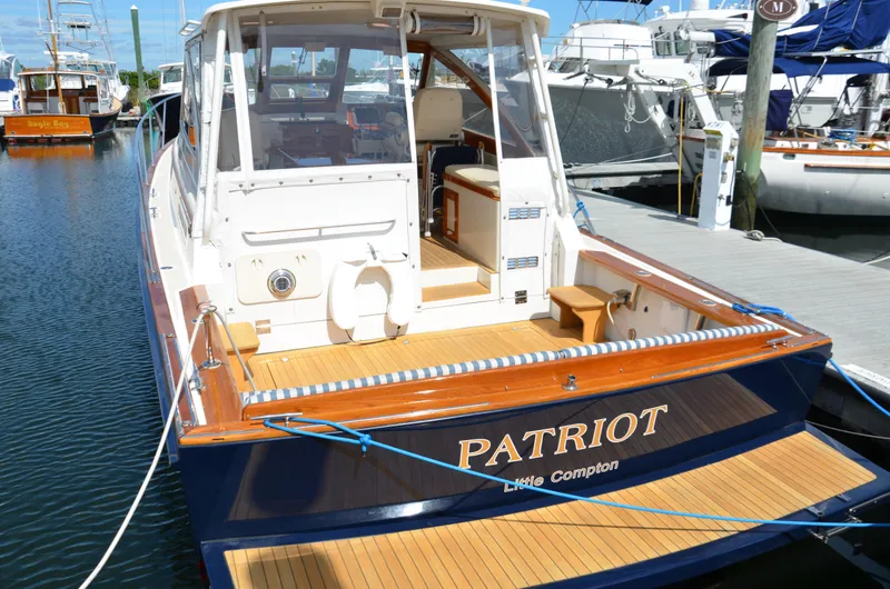 Slide: The Image of Luxurious interior of 2003 Little Harbor WhisperJet 38 with plush seating and polished wood table. - 2