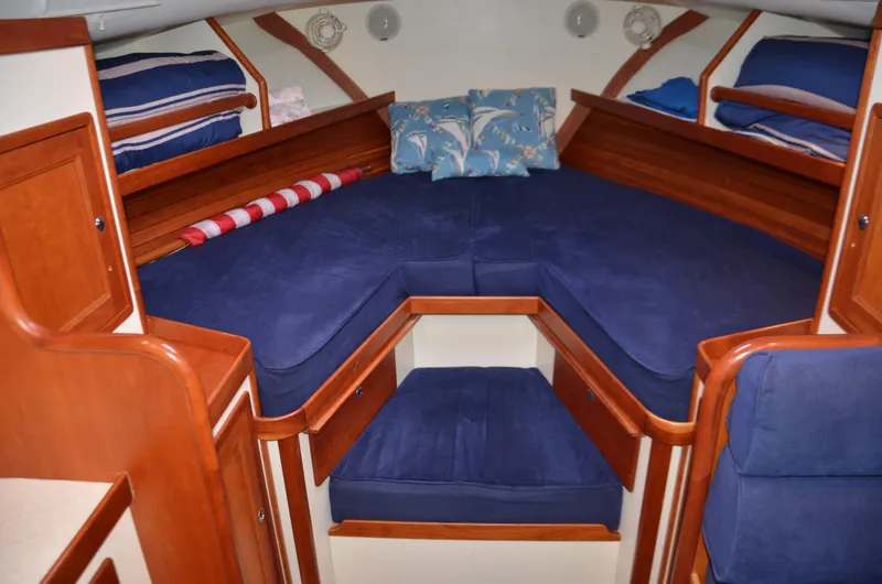 Slide: The Image of Interior of 2003 Little Harbor WhisperJet 38 with wooden flooring and blue seating. - 21