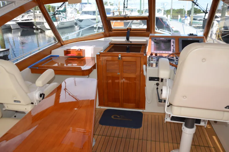 Slide: The Image of 2003 Little Harbor WhisperJet 38 docked, featuring a sleek design and wooden accents. - 5