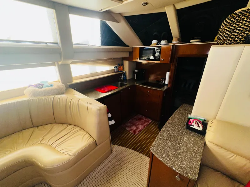 Slide: The Image of Interior of 2005 Meridian 368 Motor Yacht with cozy seating and modern kitchen amenities. - 13