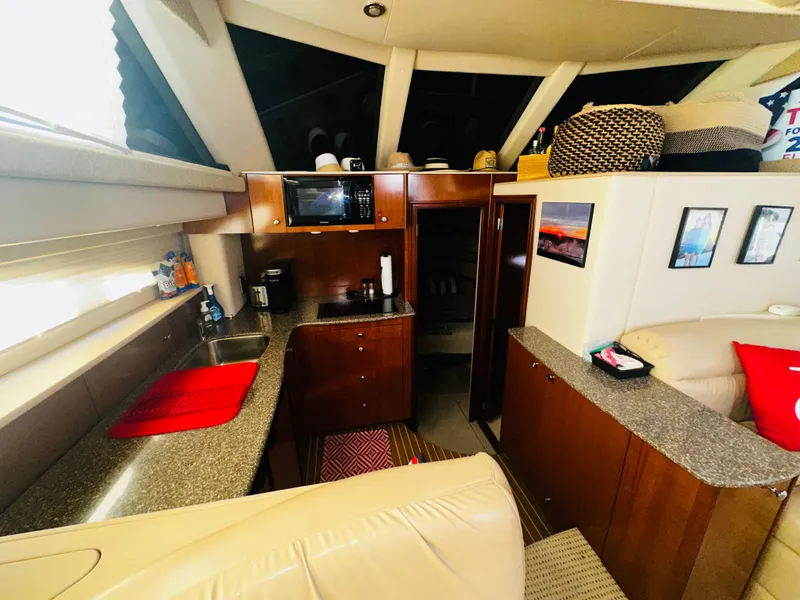 Slide: The Image of Interior of 2005 Meridian 368 Motor Yacht with modern kitchen and cozy seating area. - 16