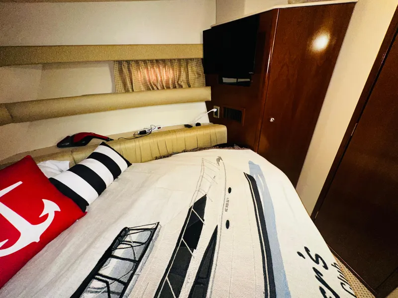 Slide: The Image of Luxurious 2005 Meridian 368 Motor Yacht cabin with nautical-themed bedding and modern amenities. - 23