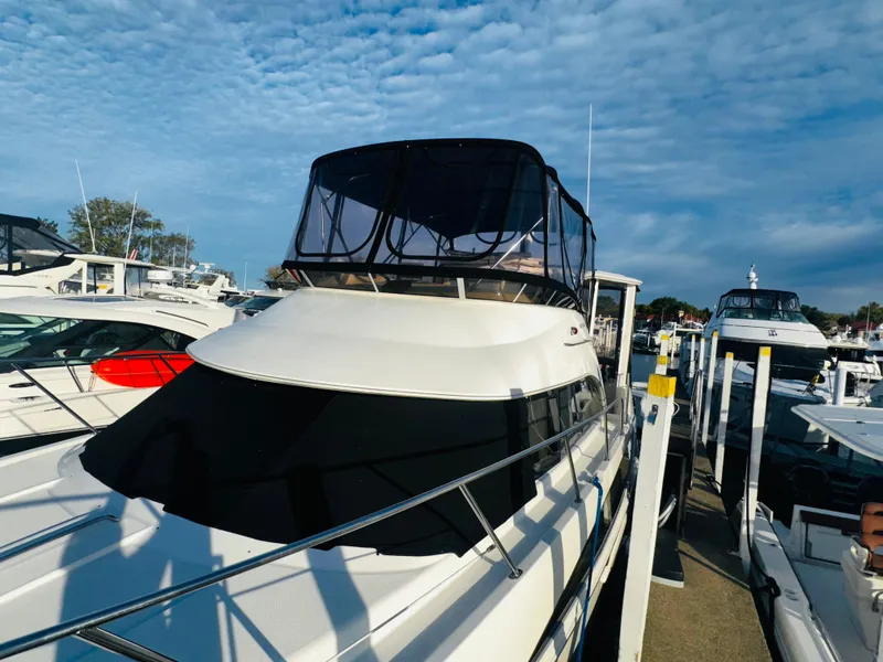 Slide: The Image of 2005 Meridian 368 Motor Yacht docked at marina under a partly cloudy sky. - 3