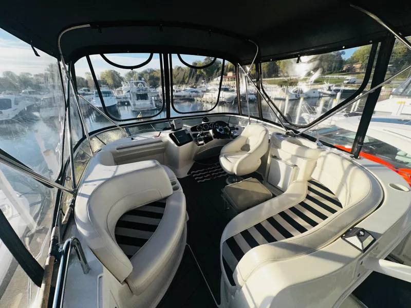 Slide: The Image of 2005 Meridian 368 Motor Yacht interior with white seating and panoramic marina view. - 5