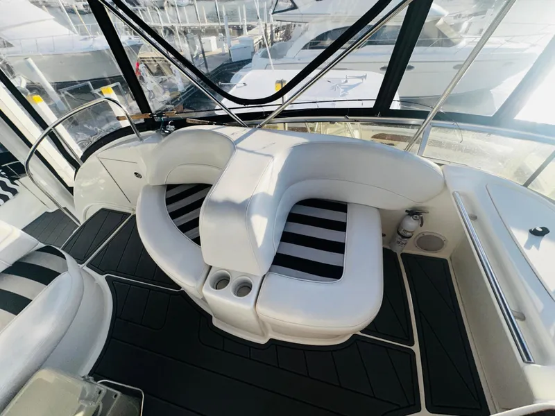 Slide: The Image of 2005 Meridian 368 Motor Yacht interior with white seating and striped cushions. - 9