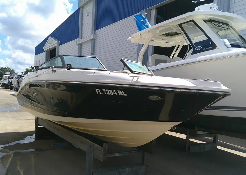 Slide: The Image of 2018 Sea Ray SPX 230 boat docked at marina, sunny day. - 1