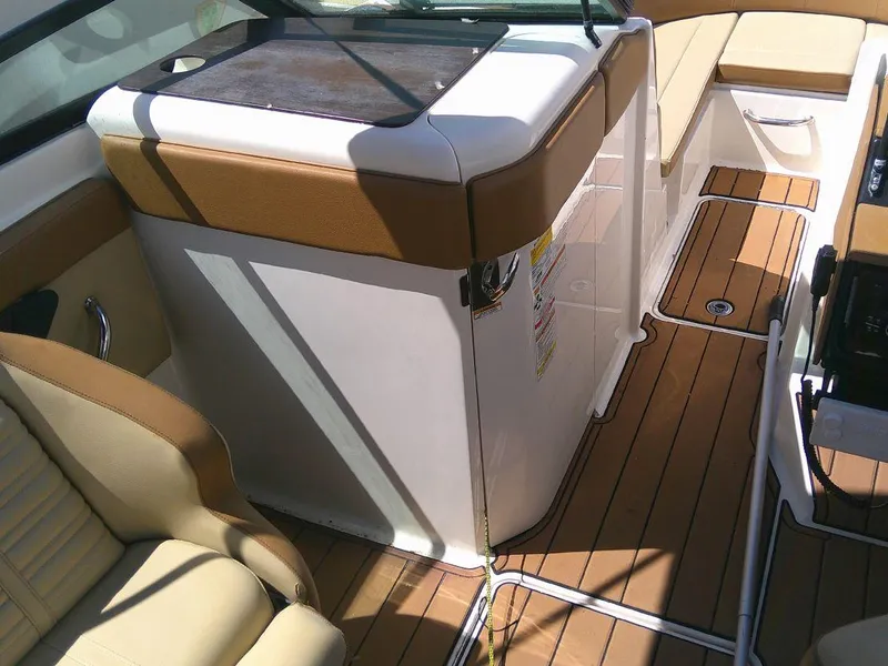 Slide: The Image of Interior of 2018 Sea Ray SPX 230 boat with tan seating and wood flooring. - 13