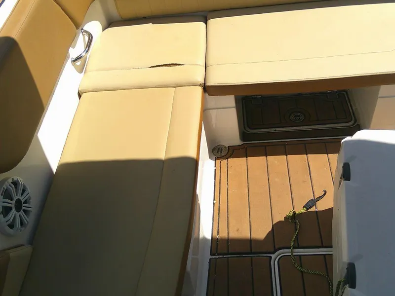 Slide: The Image of 2018 Sea Ray SPX 230 boat interior with tan seating and teak flooring. - 6