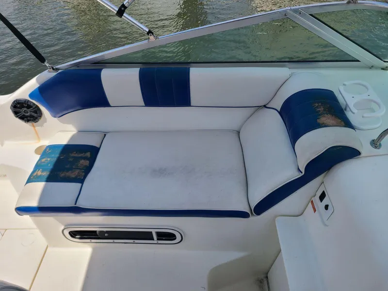 Slide: The Image of 1996 Sea Ray 240 Sundancer boat interior with blue and white seating. - 6