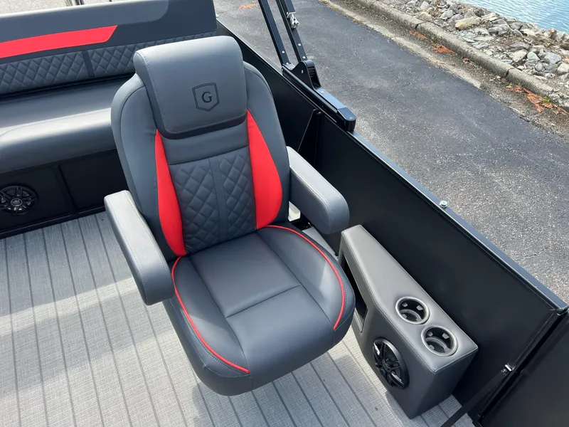 Slide: The Image of 2025 Godfrey SWEETWATER 2286 SFL boat seat with red accents and cup holders. - 15