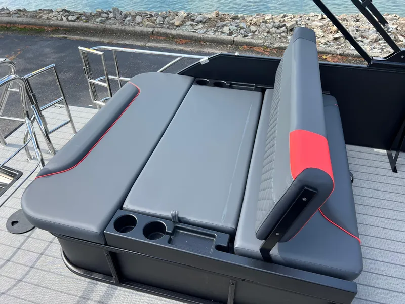 Slide: The Image of 2025 Godfrey SWEETWATER 2286 SFL boat seating with cup holders, gray and red accents. - 20