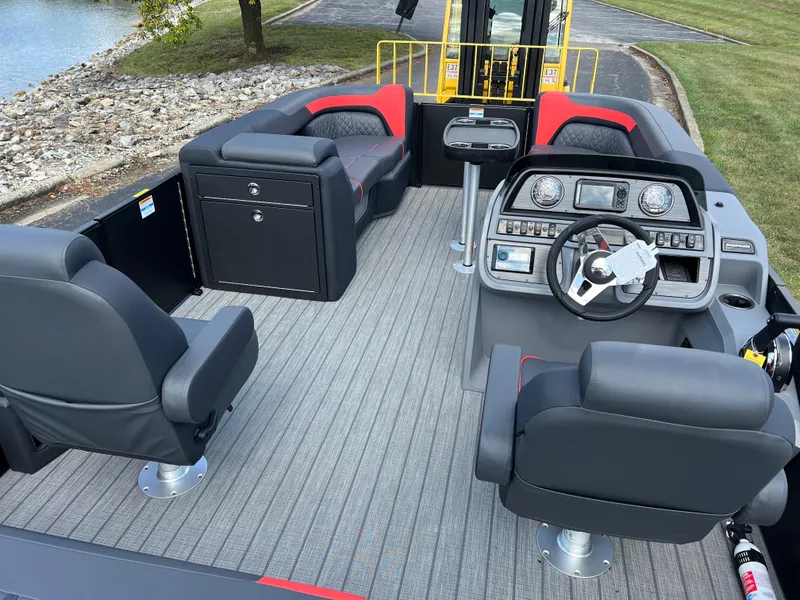 Slide: The Image of 2025 Godfrey SWEETWATER 2286 SFL boat interior with modern seating and steering console. - 24