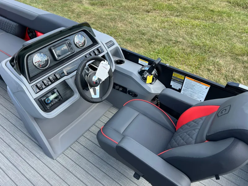 Slide: The Image of 2025 Godfrey SWEETWATER 2286 SFL boat interior with modern steering console and seating. - 25