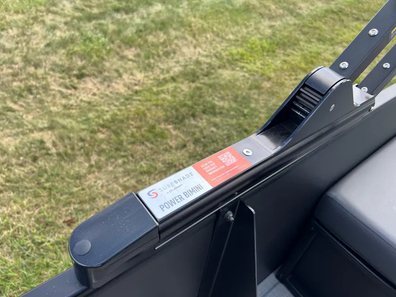 Slide: The Image of Power Bimini control on 2025 Godfrey SWEETWATER 2286 SFL boat, grassy background. - 29