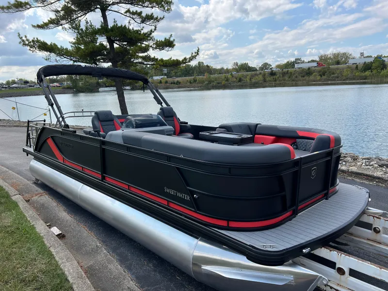 Slide: The Image of 2025 Godfrey SWEETWATER 2286 SFL pontoon boat by a scenic lake. - 4