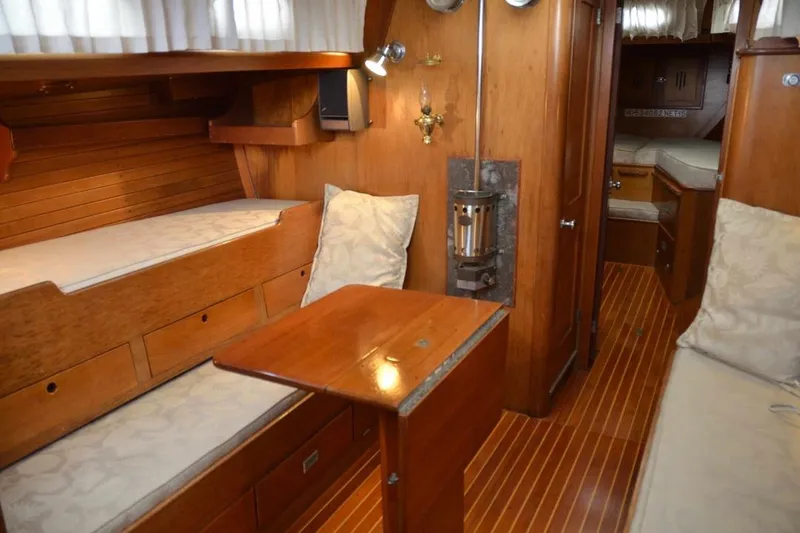 Slide: The Image of Interior of a 1971 Hinckley Bermuda 40 sailboat with wooden furnishings and cozy seating. - 10