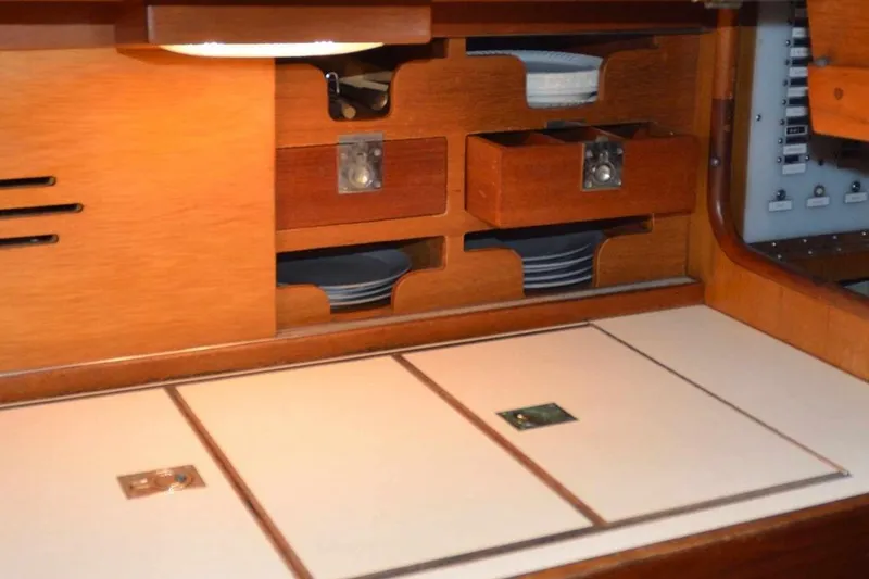 Slide: The Image of Interior of 1971 Hinckley Bermuda 40 yacht with wooden cabinetry and storage compartments. - 7