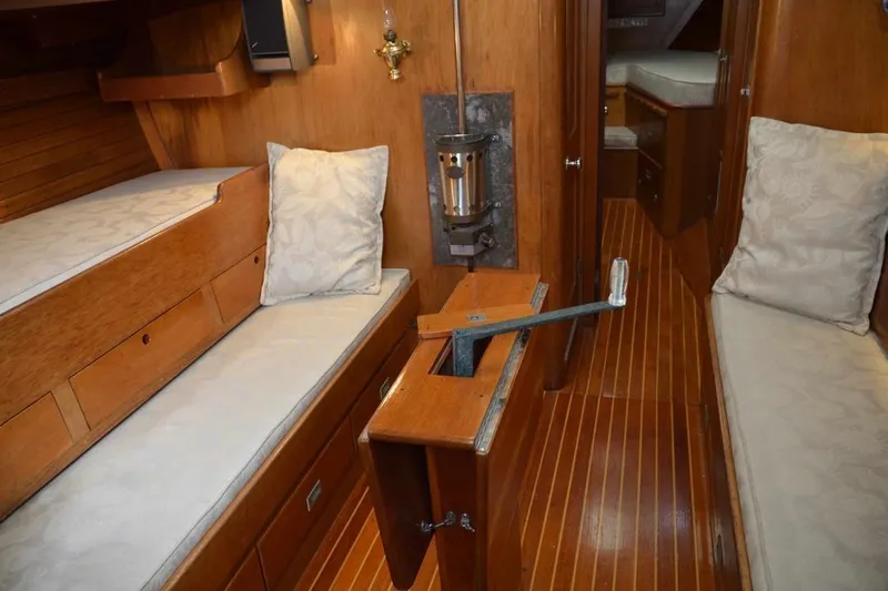 Slide: The Image of Interior of 1971 Hinckley Bermuda 40 sailboat with wooden furnishings and cozy seating. - 12