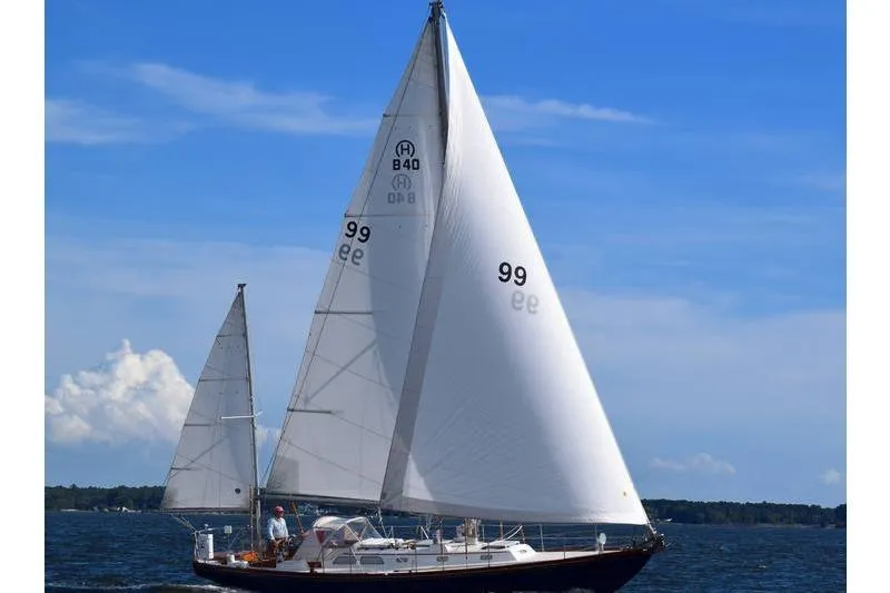 Slide: The Image of 1971 Hinckley Bermuda 40 sailboat on open water under clear blue sky. - 16