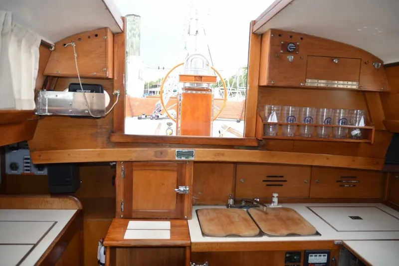 Slide: The Image of Interior of 1971 Hinckley Bermuda 40 sailboat with wooden cabinetry and helm view. - 9