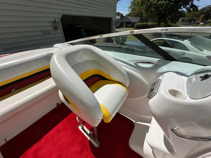 Slide: The Image of Interior of a 2001 Baja 232 boat with white and yellow seating. - 10