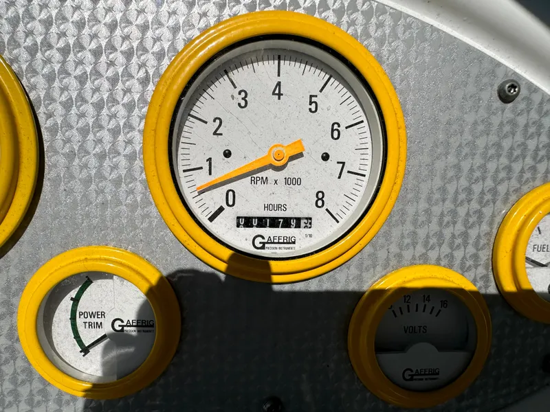 Slide: The Image of Close-up of Baja 232 boat dashboard gauges, featuring RPM, power trim, and volts indicators. - 16