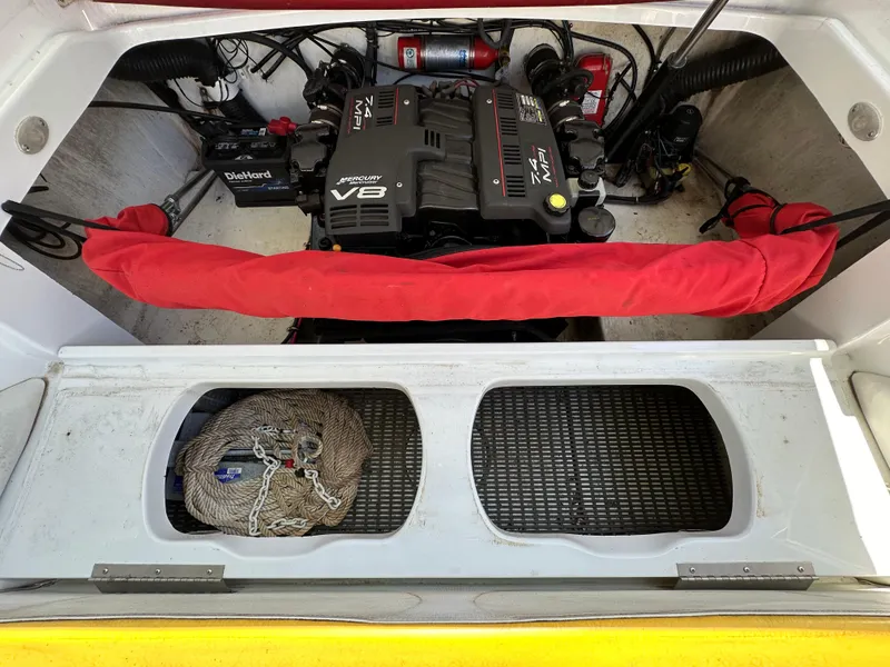 Slide: The Image of Engine compartment of a 2001 Baja 232 boat featuring a powerful V8 engine. - 21