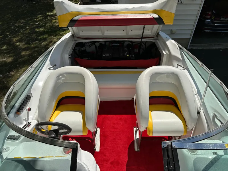 Slide: The Image of 2001 Baja 232 boat interior with red carpet and white-yellow seats. - 22