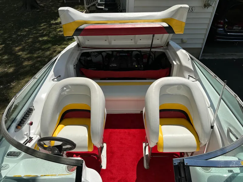 Slide: The Image of 2001 Baja 232 boat interior with red carpet and white-yellow seats. - 23