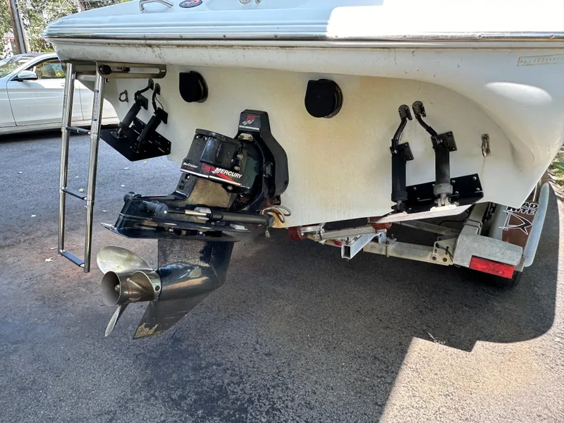 Slide: The Image of Rear view of a 2001 Baja 232 boat on a trailer, showing the propeller and outdrive. - 25