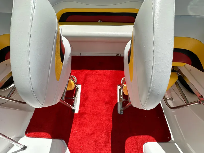 Slide: The Image of Interior of 2001 Baja 232 boat with red carpet and white seats. - 9