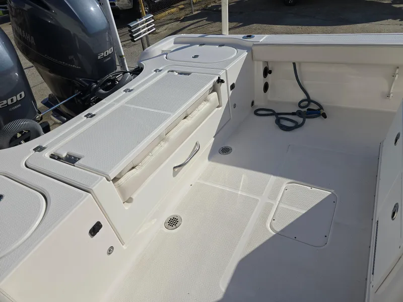 Slide: The Image of 2021 Blue Wave 2800 Makaira boat deck with storage and twin engines. - 11