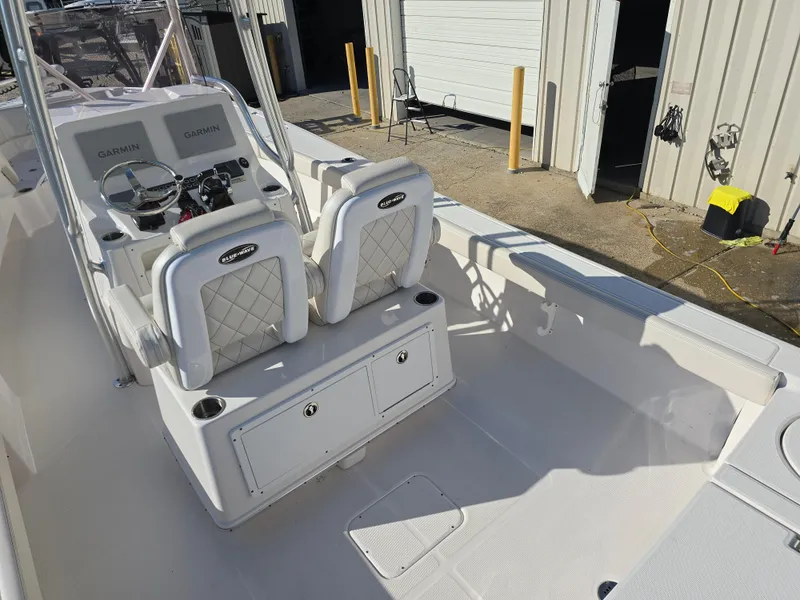 Slide: The Image of 2021 Blue Wave 2800 Makaira boat interior with dual seats and steering console. - 12