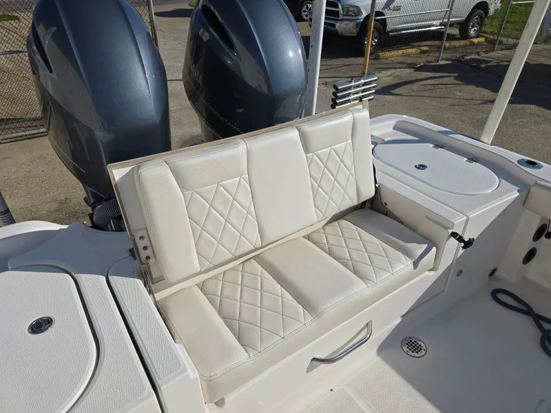 Slide: The Image of 2021 Blue Wave 2800 Makaira boat with cushioned seating and dual outboard motors. - 13