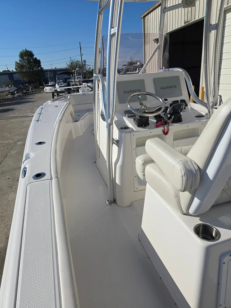 Slide: The Image of 2021 Blue Wave 2800 Makaira boat interior with steering console and seating. - 17