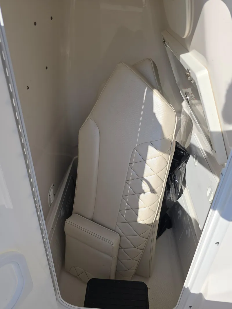 Slide: The Image of 2021 Blue Wave 2800 Makaira boat interior storage with cushioned seats. - 19