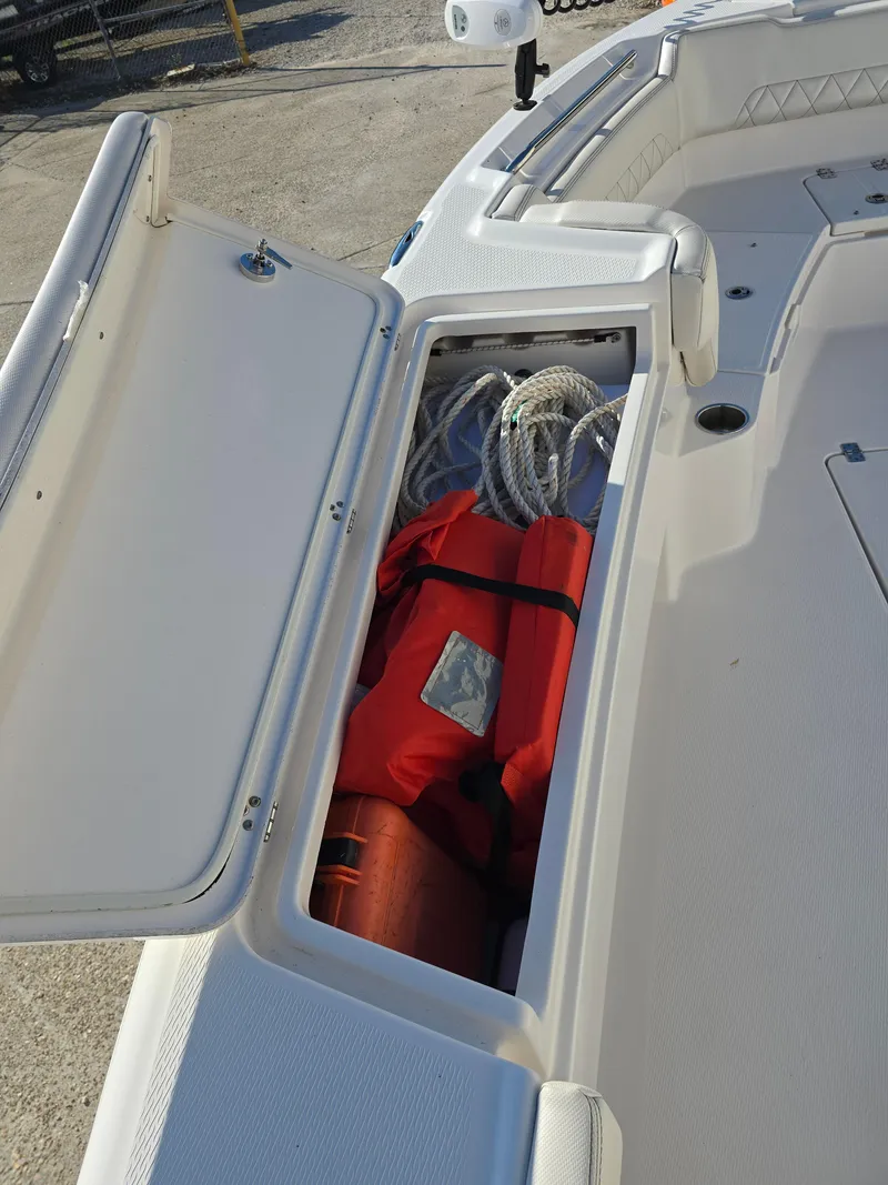 Slide: The Image of 2021 Blue Wave 2800 Makaira boat storage with life jacket and ropes. - 24