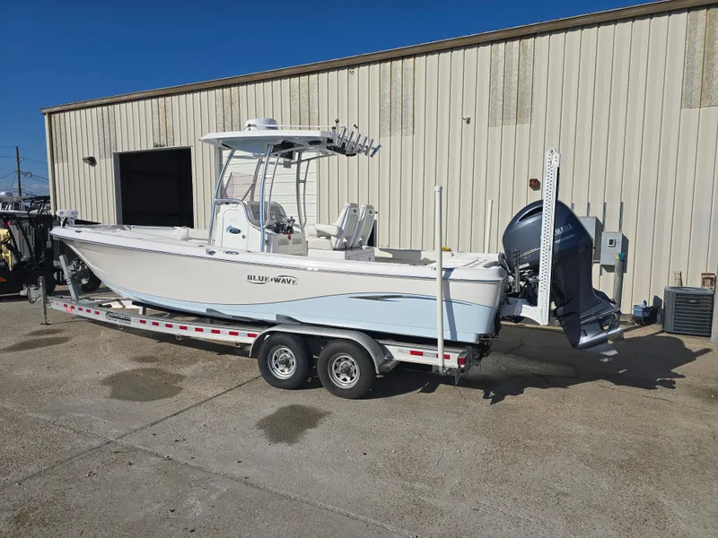 Slide: The Image of 2021 Blue Wave 2800 Makaira boat on trailer, parked outside a warehouse. - 3